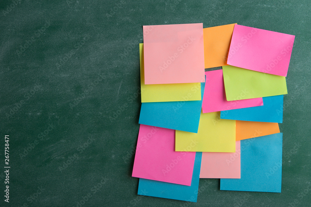 Colorful sticky notes on the blank blackboard Colorful sticky notes on the blank blackboard