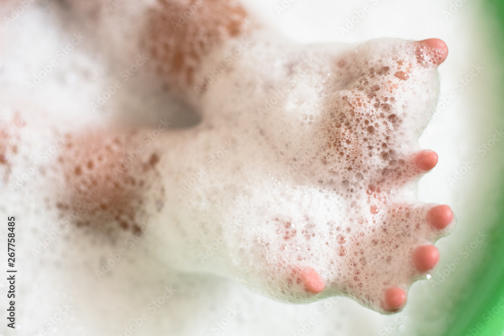 CChild hands in a soap foam bubbles. Concept of hygiene and childhood activities. Selective focus CChild hands in a soap foam bubbles. Concept of hygiene and childhood activities. Selective focus