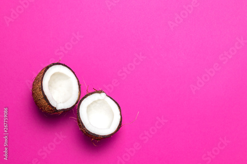 the halved coconut on pink background