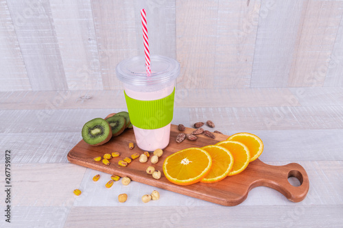 Fresh smoothie on wodeen table, assorted protein cocktails with nuts and fresh fruits photo