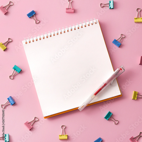 Flat lay picture with blank open notepad and different accessories on colored surface.