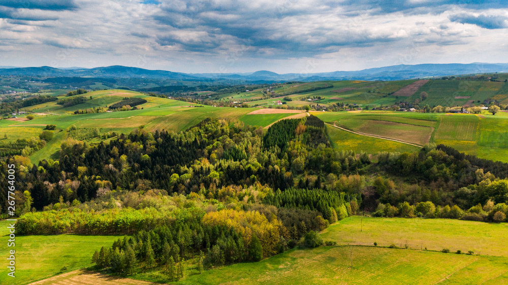 Green hills with meadows and forest, aerial view of polish countryside