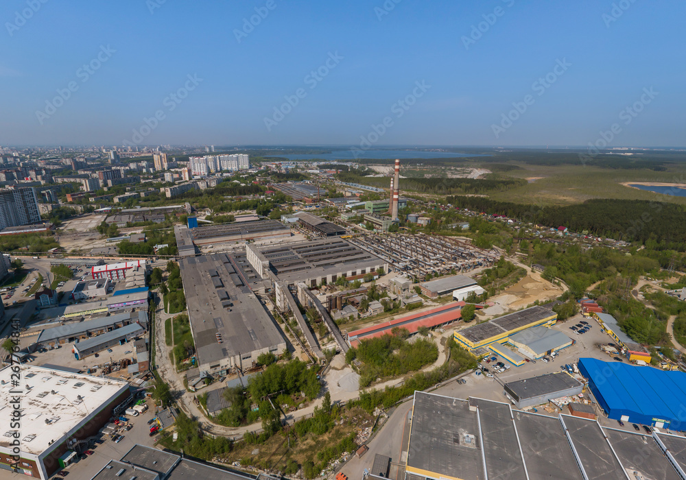 Top down aerial drone image of a Ekaterinburg city and Factory in the early summer, backyard turf grass and trees lush green