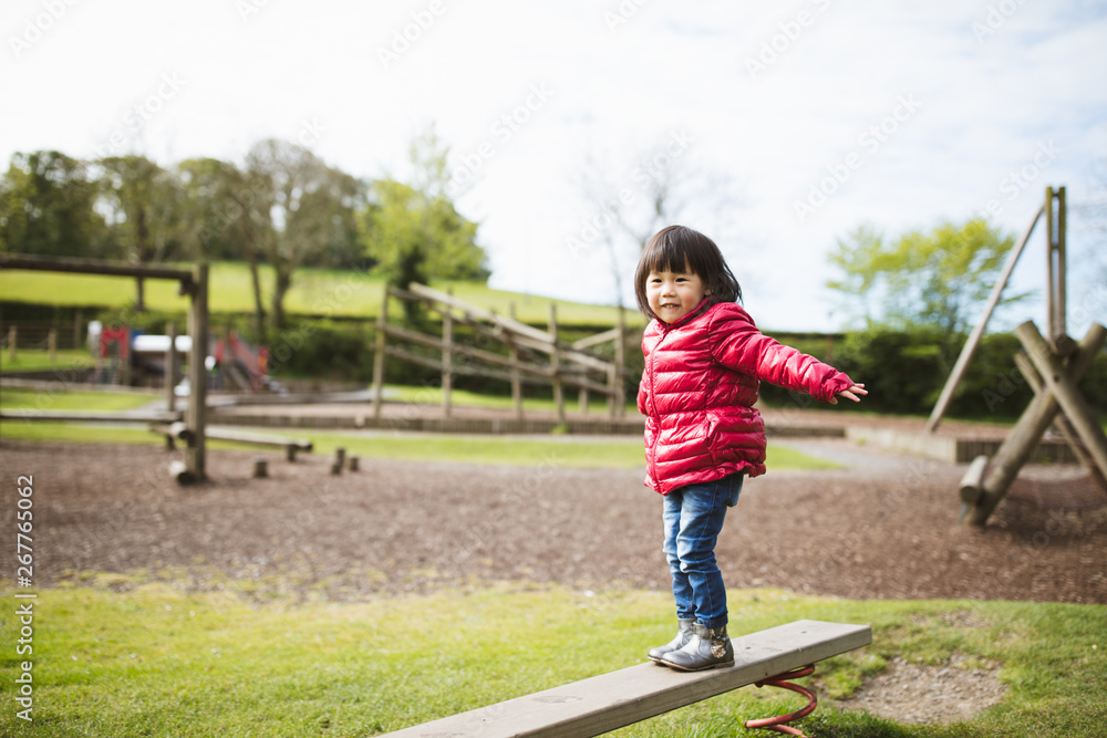 Fototapeta premium toddler girl play at outdoor playground