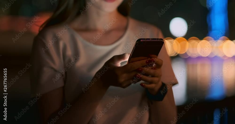 Close-up girl holding smartphone at night Close-up girl holding smartphone at night