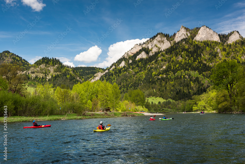 Adventure kayaking and rafting on Dunajec river, Three Crowns mountains peak in background