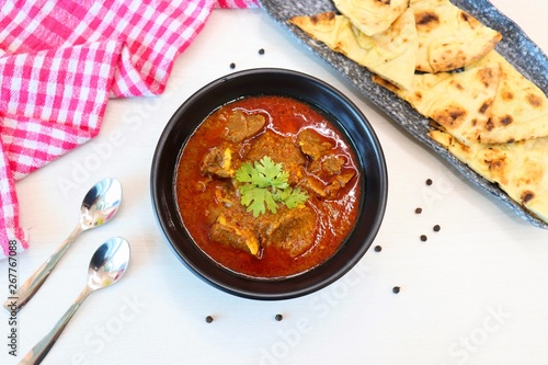 Fotografie Mutton do Pyaza or Indian lamb Curry with some spices like black pepper, red chi