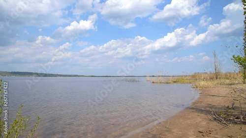 Wallpaper Mural Sandy river bank with calm water and blue sky with white clouds Torontodigital.ca