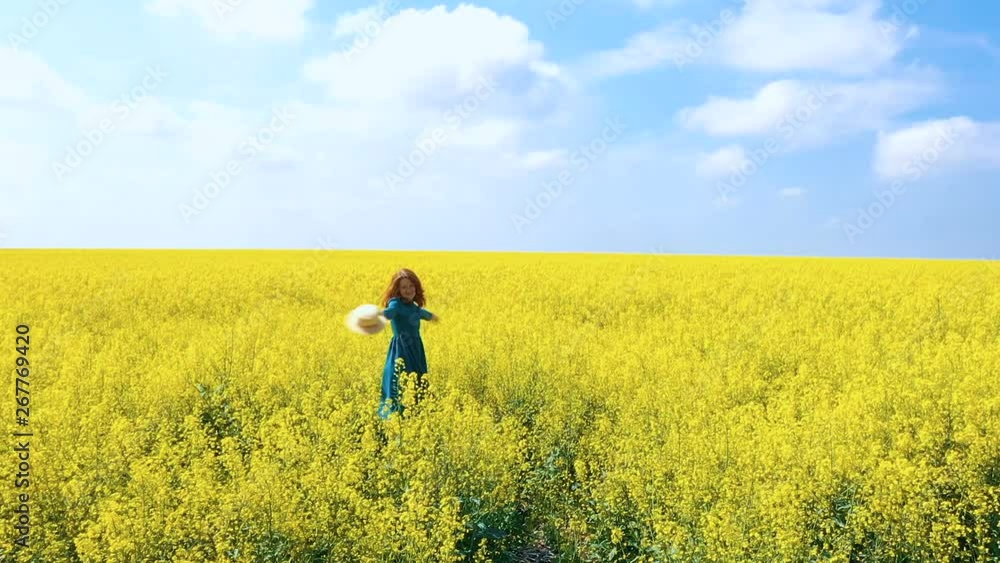 happy beautiful girl enjoying at the blooming rapeseed field at bright sunny day happy beautiful girl enjoying at the blooming rapeseed field at bright sunny day