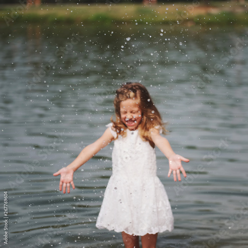 Fototapeta Naklejka Na Ścianę i Meble -  cute happy little girls in sumer lake