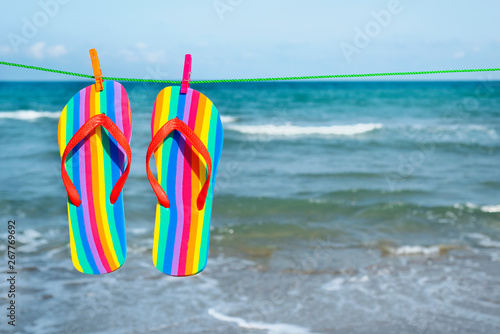 rainbow flip-flops hanging on a clothes line