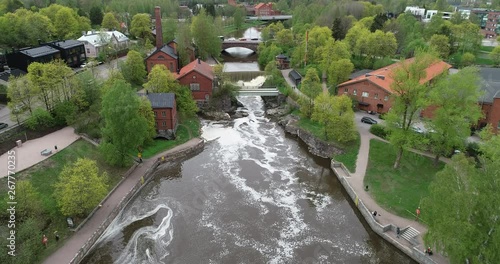 Aerial footage of Vanhankaupunginkoski waterfall on Vantaanjoki River and Power Plant Museum buildings located in Old Helsinki on the Western fork of the Vantaa River. photo