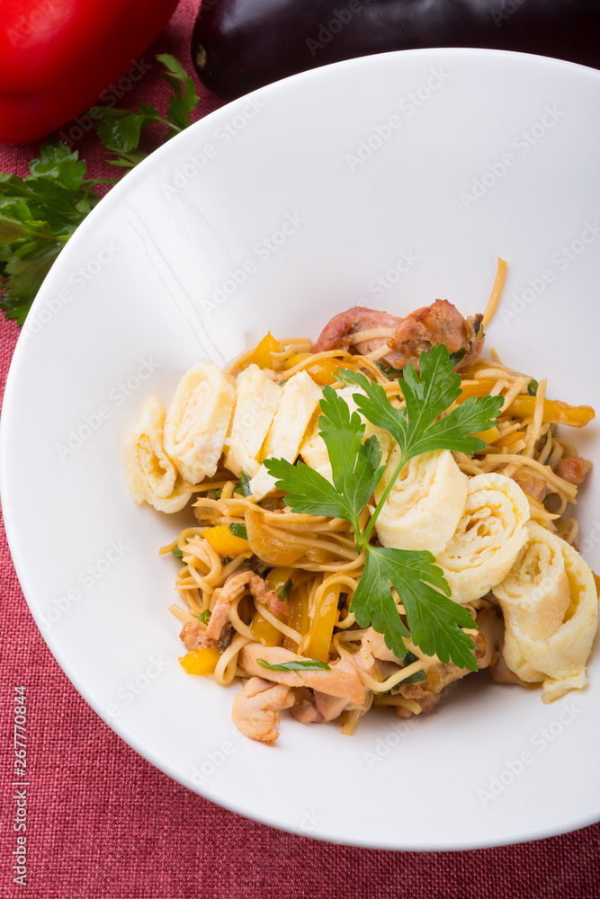 Stir-fried noodles served with egg omelette Stir-fried noodles served with egg omelette