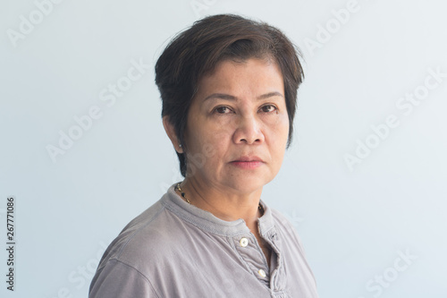 portrait of middle aged old woman with wrinkle skin and slight grey hair