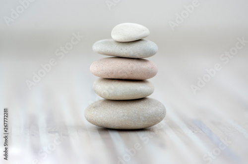 Harmony and balance  cairns  simple poise stones on wooden light white gray background  simplicity rock zen sculpture