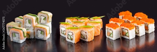 Elite sushi rolls on a black background. Assortment of rolls with different fillings.