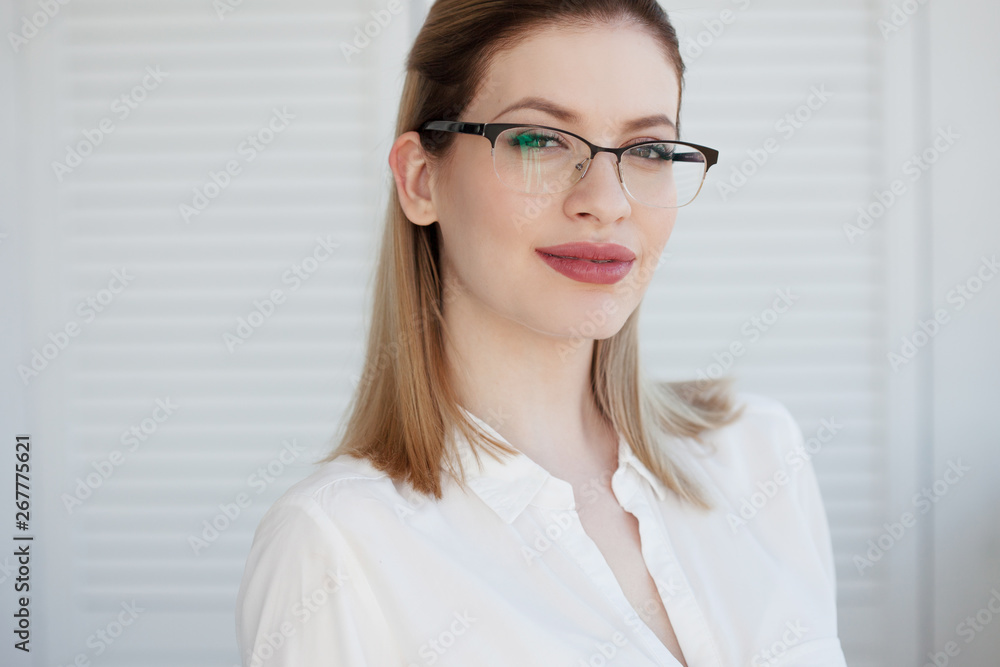 Young business lady in white shirt and glasses. Attractive young woman smiling Young business lady in white shirt and glasses. Attractive young woman smiling