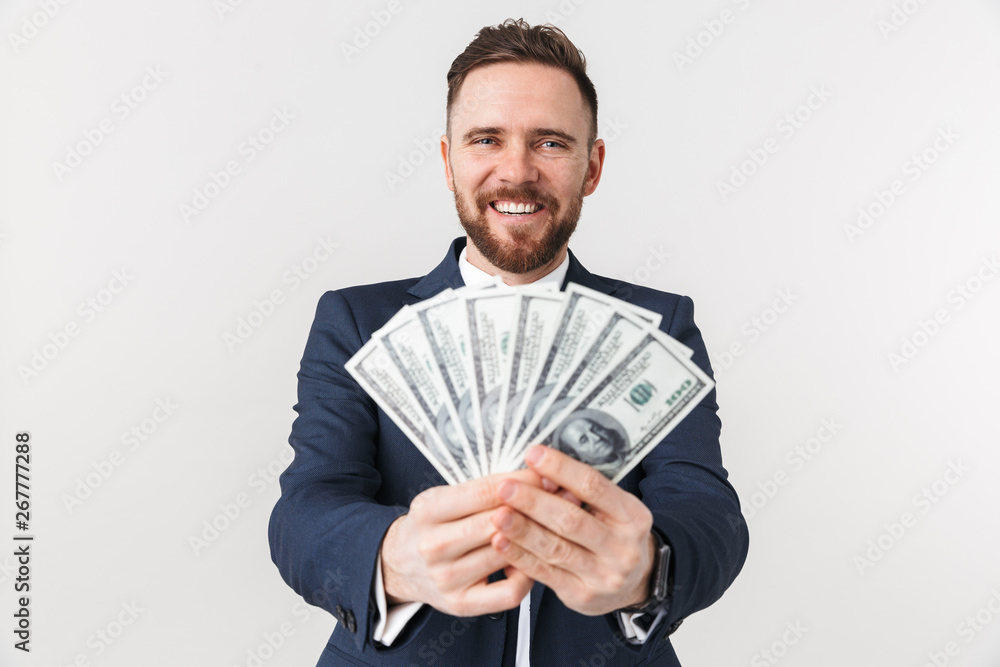 Businessman posing isolated over white wall background with money. Businessman posing isolated over white wall background with money.