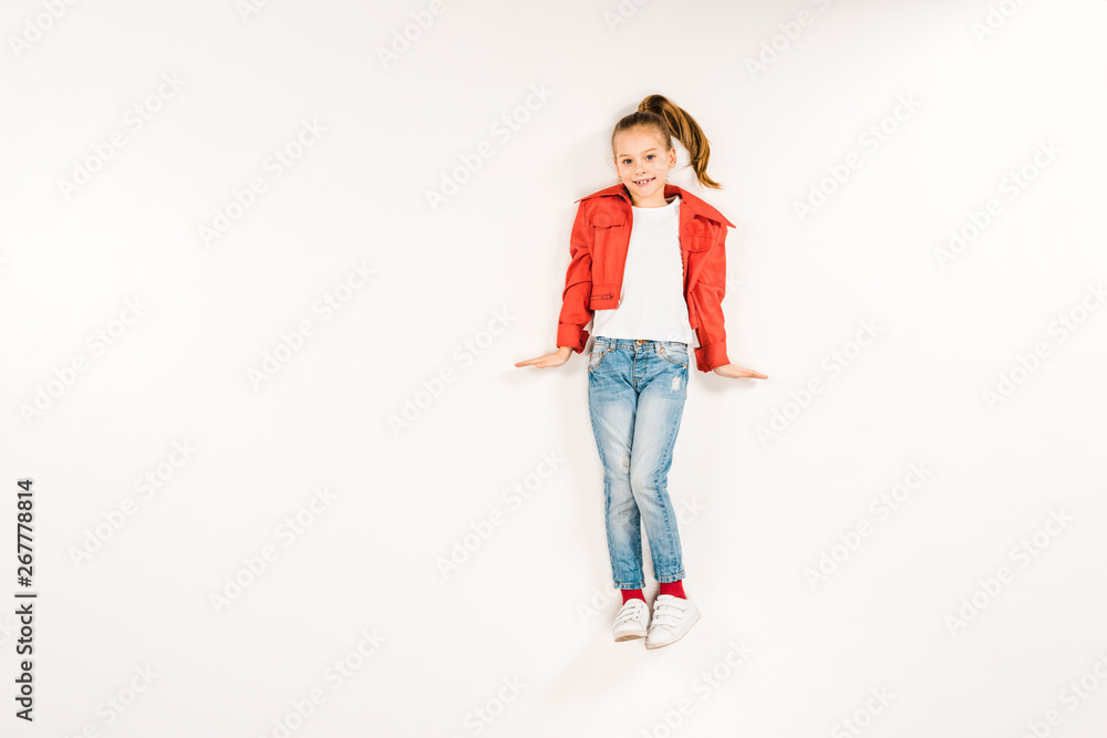 top view of happy child looking at camera and smiling on white top view of happy child looking at camera and smiling on white