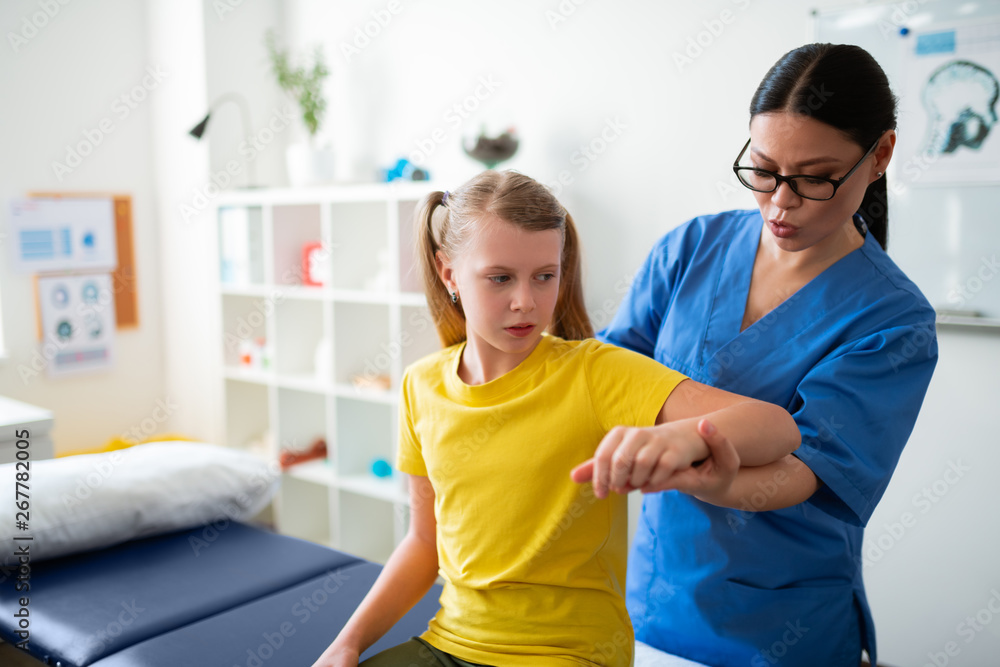 Fototapeta premium Concentrated dark-haired professional doctor being concerned with state