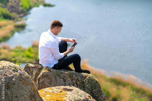 Obraz na płótnie Young man checking his mobile for messages w salonie