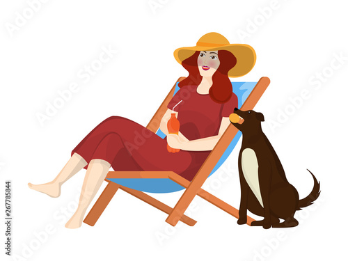 Beautiful woman drinking soft drink and sitting on beach chair with dog.