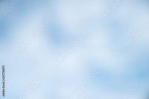 Blurred soft background. Blurred summer background of blue sky with clouds. The effect of the defocus of the open aperture.