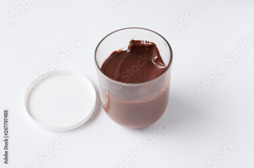 Tasty chocolate spread in jar isolated on white background