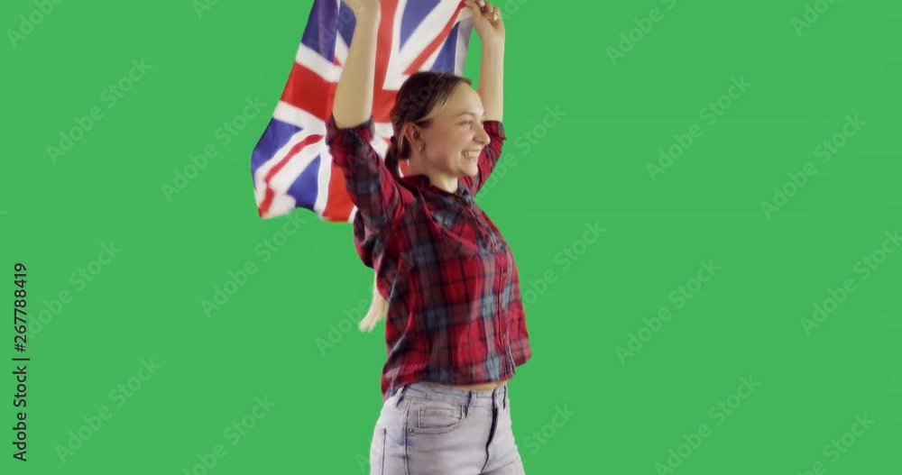 Happy attractive woman run with the English flag on chroma key green screen. Happy attractive woman run with the English flag on chroma key green screen.