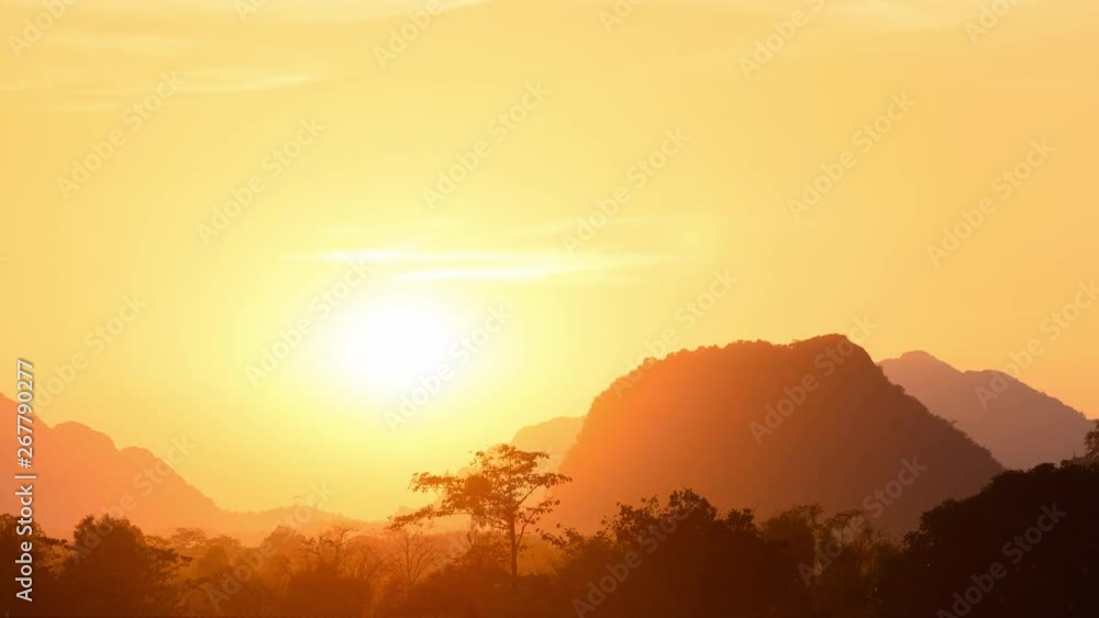 Panorama golden sunset over scenic cliffs and rock pinnacles, rainforest silhouette. Vang Vieng backpacker travel destination in Laos, Asia Panorama golden sunset over scenic cliffs and rock pinnacles, rainforest silhouette. Vang Vieng backpacker travel destination in Laos, Asia