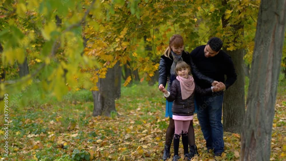 happy family dad mom and daughter in autumn park happy family dad mom and daughter in autumn park