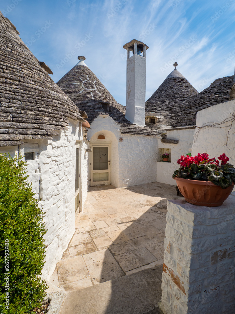 ALBEROBELLO, ITALY - April, 2019: Alberobello's famous Trulli, the characteristic cone-roofed houses of the Itria Valley, Apulia, Southern Italy.