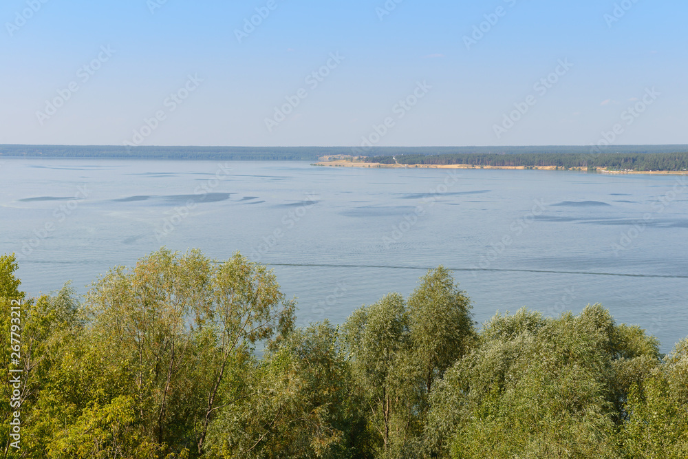 Summer landscape overlooking the wide river from a height