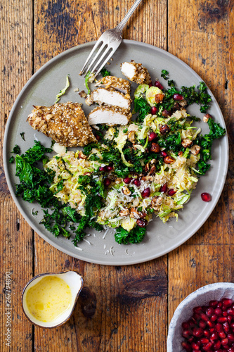 Quinoa, brussel sprouts, crispy kale and hazelnuts salad with dukkah crusted chicken  photo