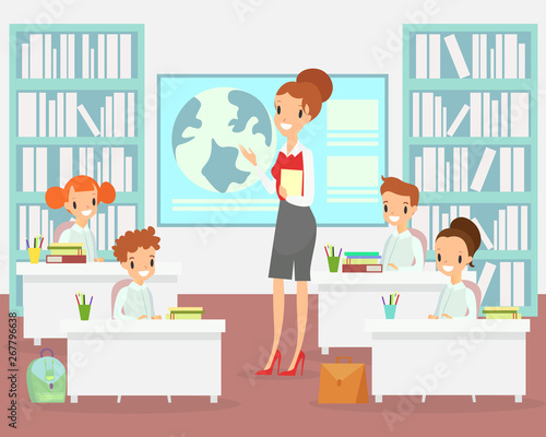 Vector illustration of teacher in classroom with kids. Teacher with children in elementary school class, preschool studying. Happy and smiley kids sitting at the desks in class, cartoon flat style.