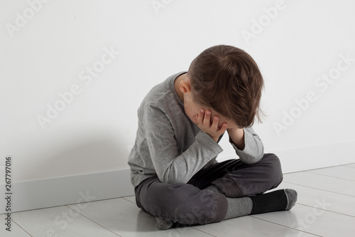 a child whose depression is sitting on the floor © vovan