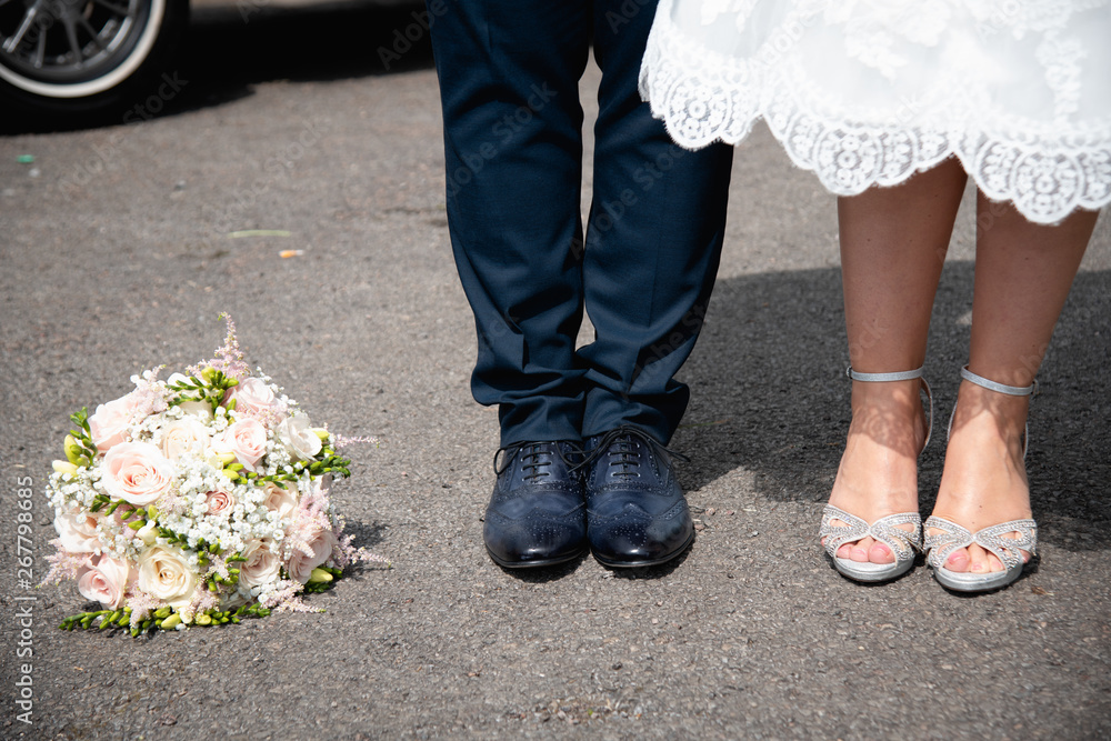 Feet of Bride and Groom with Wedding Flower Bouquet Feet of Bride and Groom with Wedding Flower Bouquet