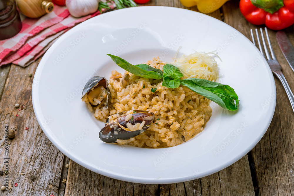 risotto with seafood on wooden background