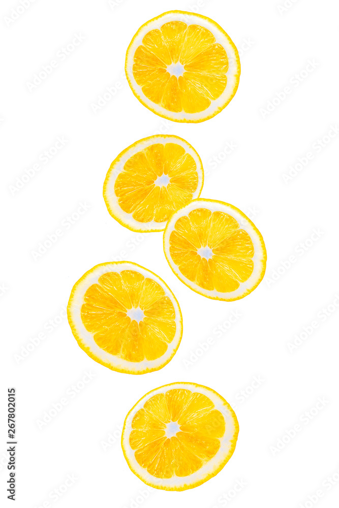 Sliced cut yellow lemon fruits flying. Isolated on white background. Citrus fruit. Falling pieces of lemons in the air.