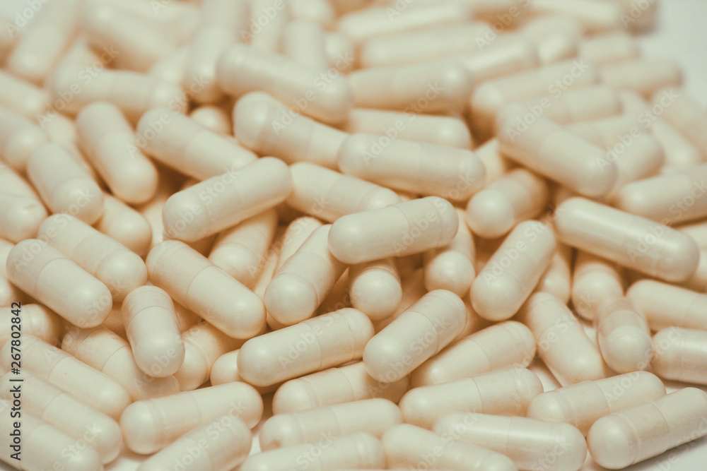 Set of many pills. Yellow capsules on white background. Health care pattern concept. Set of many pills. Yellow capsules on white background. Health care pattern concept.