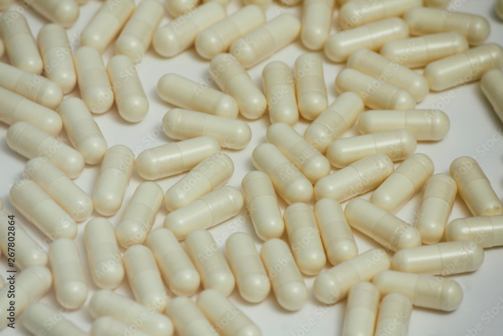 Set of many pills. Yellow capsules on white background. Health care pattern concept. Set of many pills. Yellow capsules on white background. Health care pattern concept.