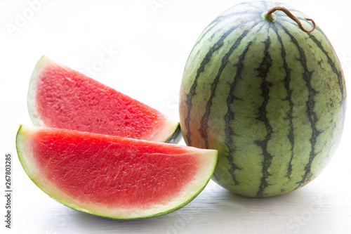 Watermelon cut into pieces on a wooden cutting board placed on the table,Summer fruit that is juicy