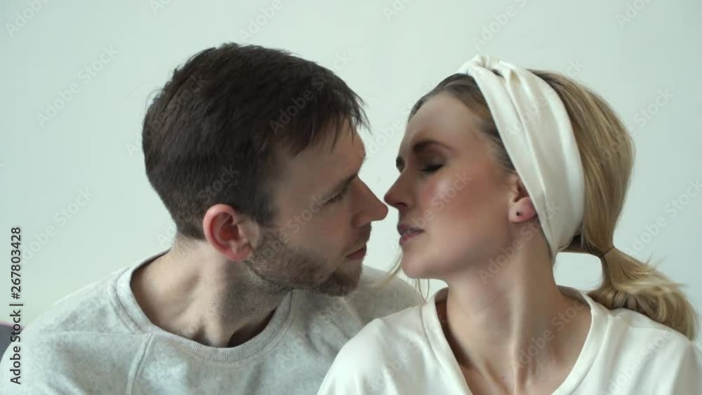 Young beautiful caucasian couple looks at each other and kisses. Нappy family Young beautiful caucasian couple looks at each other and kisses. Нappy family