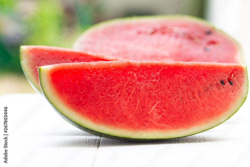 Watermelon cut into pieces on a wooden cutting board placed on the table,Summer fruit that is juicy Watermelon cut into pieces on a wooden cutting board placed on the table,Summer fruit that is juicy