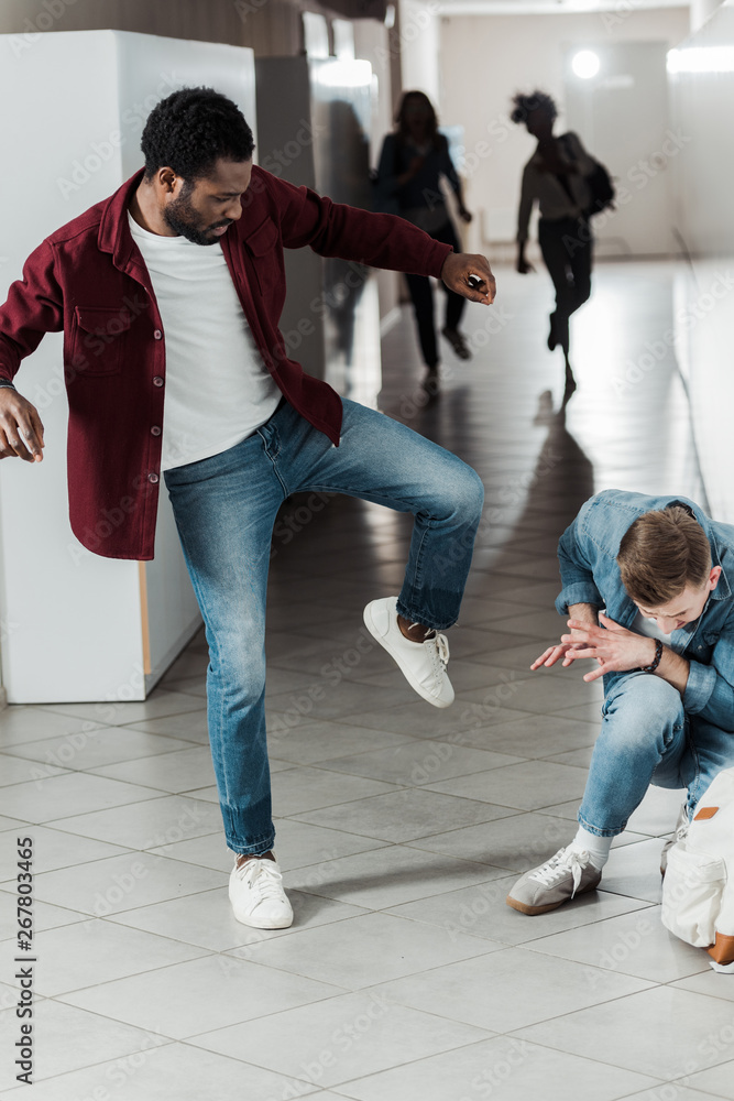 two students in jeans fighting in corridor in college two students in jeans fighting in corridor in college