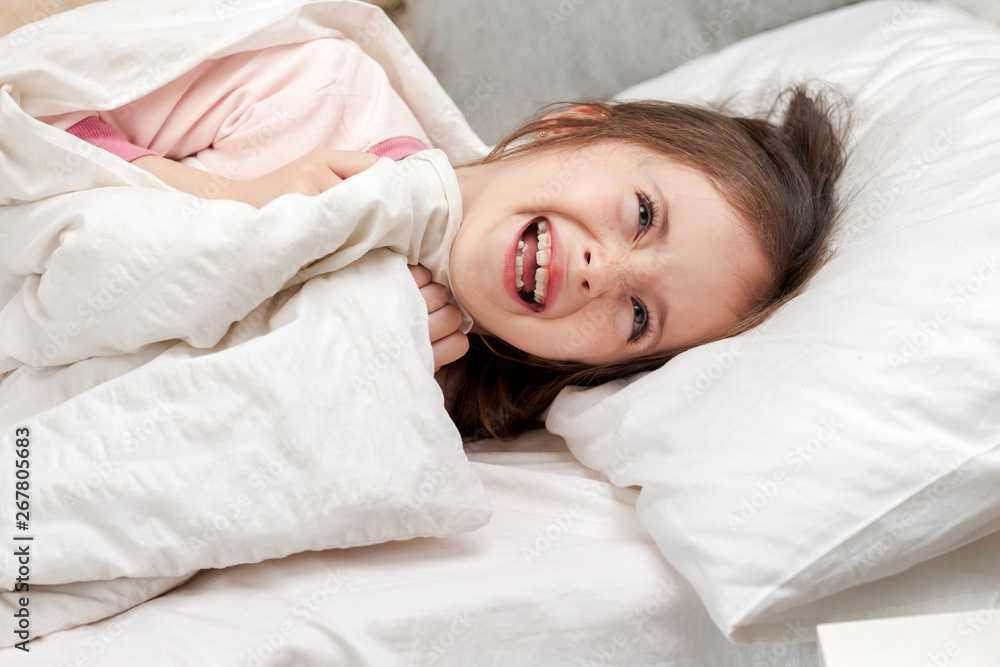 cute little child girl wakes up from sleep in bed in the morning cute little child girl wakes up from sleep in bed in the morning