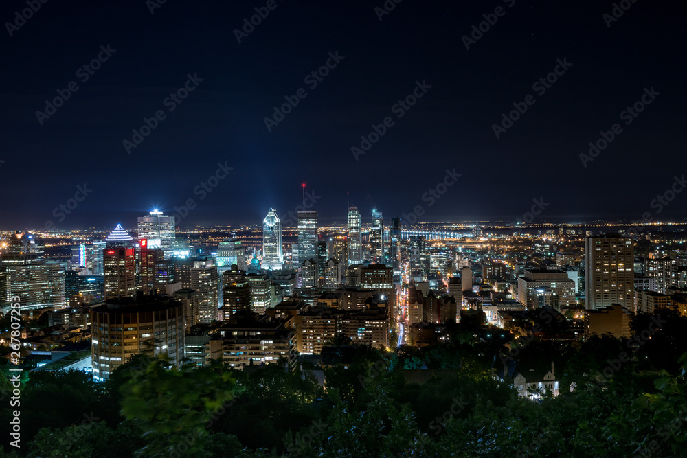 Montreal urban skyline in a summer night with tall skyscarapers and blue sky