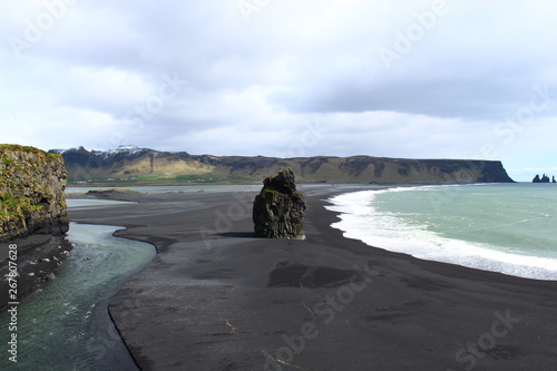 black beach, rock and sea