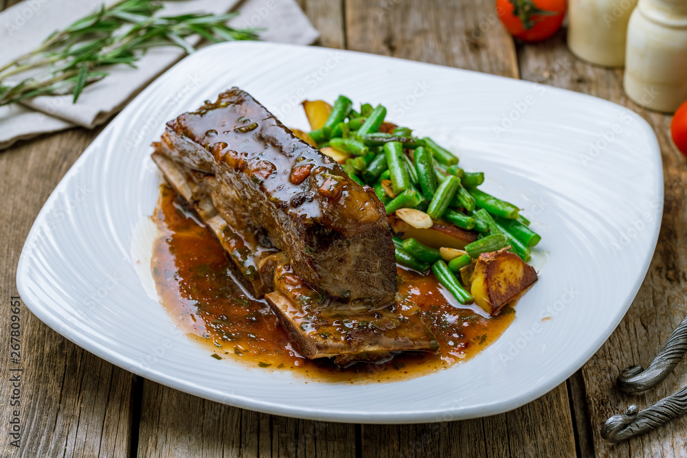beef ribs on bone on white plate beef ribs on bone on white plate