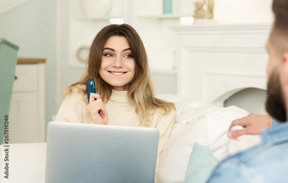 Please, Buy! Woman Asking Husband Order Clothes, Holding Credit Card Please, Buy! Woman Asking Husband Order Clothes, Holding Credit Card